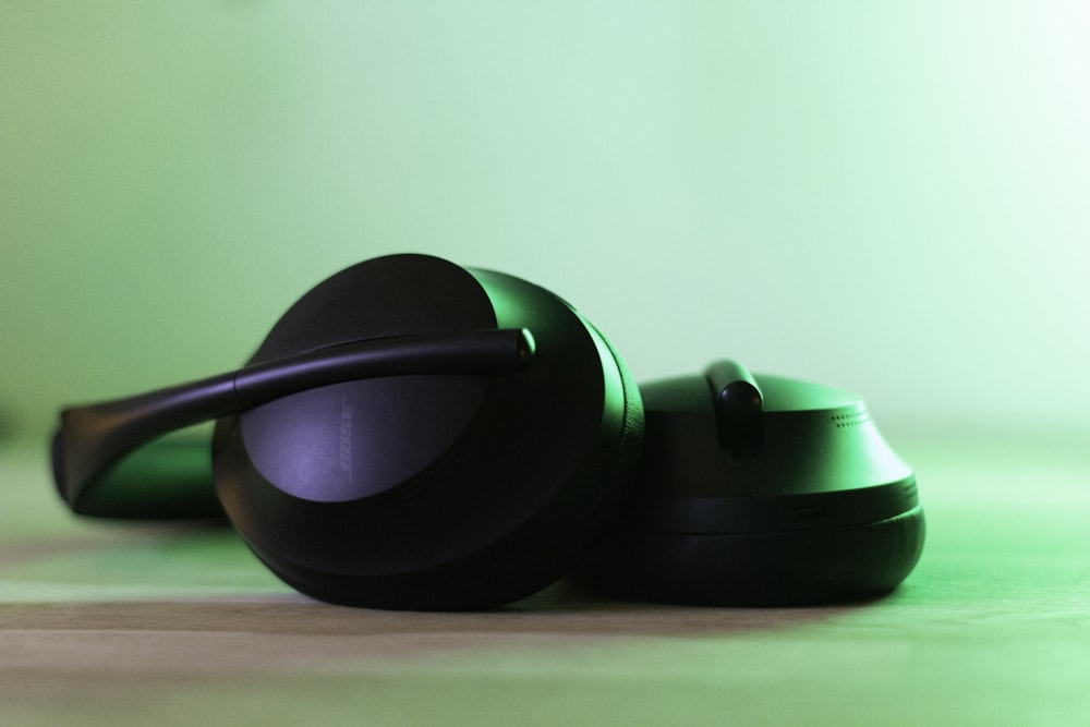 black and green headphones on green surface