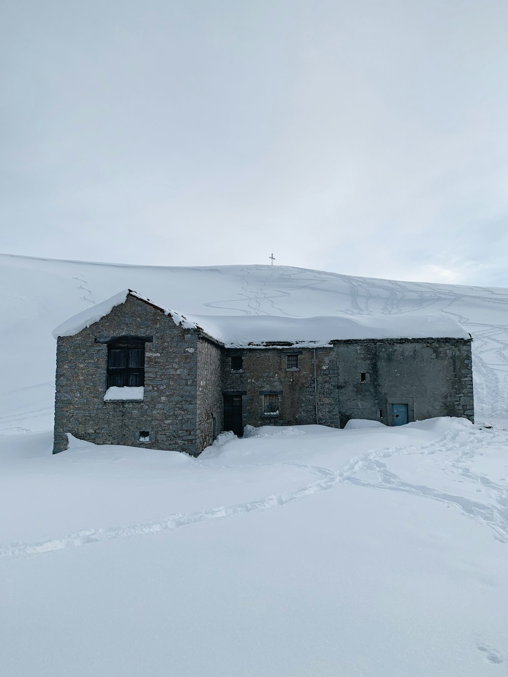 gray concrete house on snow covered ground