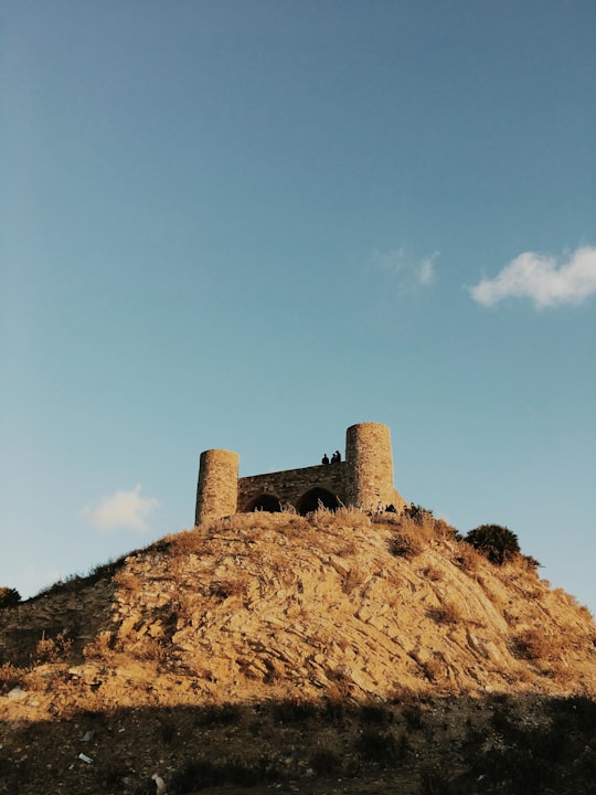 brown rock formation under blue sky during daytime in Tangier Morocco