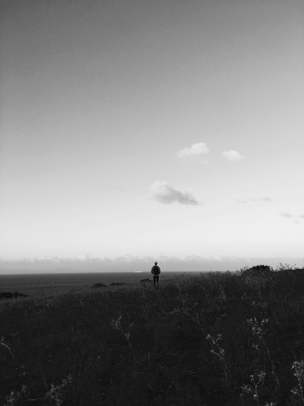 person standing on grass field during daytime