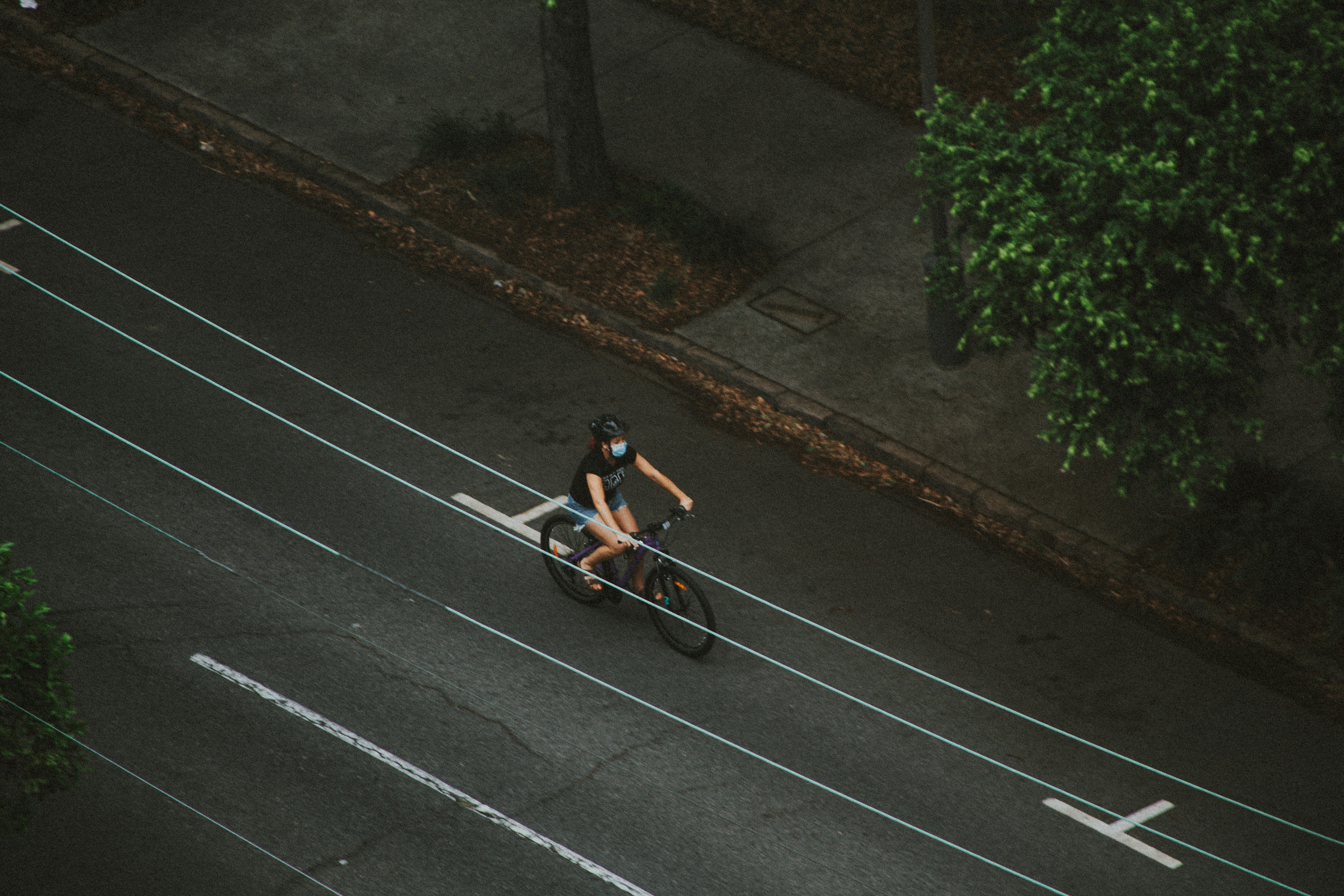 man in black t-shirt riding bicycle on road during daytime