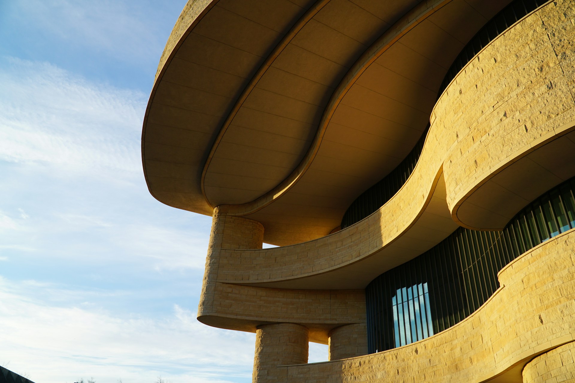 woman wearing yellow long-sleeved dress under white clouds and blue sky during daytime