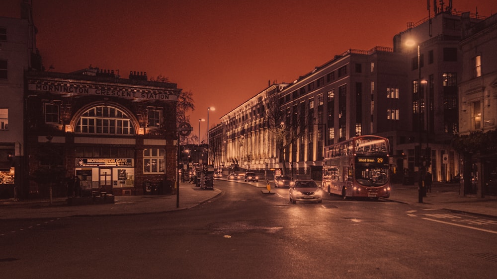 cars parked on side of the road in front of building during night time