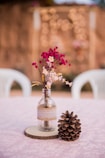 pink and white flowers in clear glass vase on white table