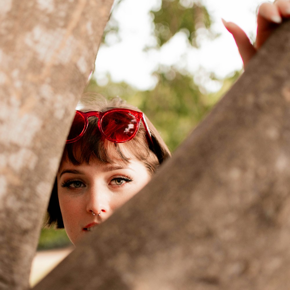 woman in red framed sunglasses