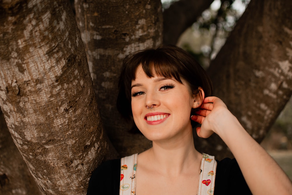 woman in white and red floral tank top smiling