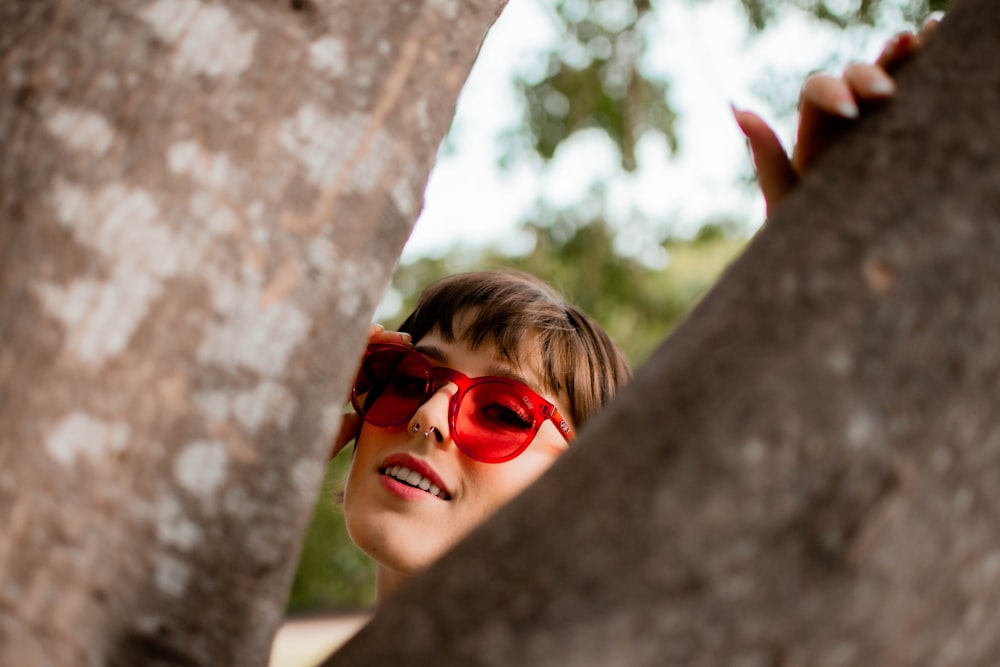 woman in red framed sunglasses