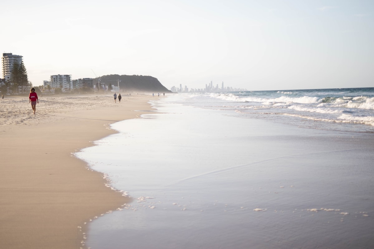 Surfers Paradise high-rise skyline meeting the beach at sunset