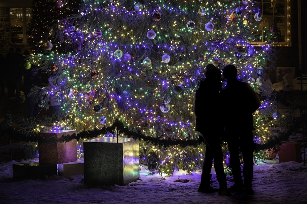 silhouette of 2 person standing near bubbles