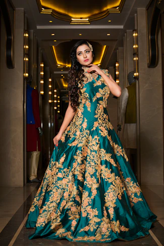 A sophisticated woman in an opulent dark-hued Italian ladies suit with gold accents, standing in a classic Italian villa setting.