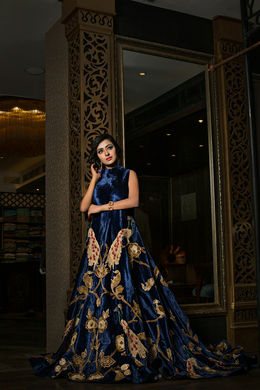 woman in blue and gold floral sleeveless dress