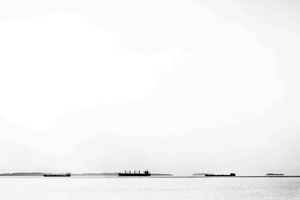 grayscale photo of boat on sea