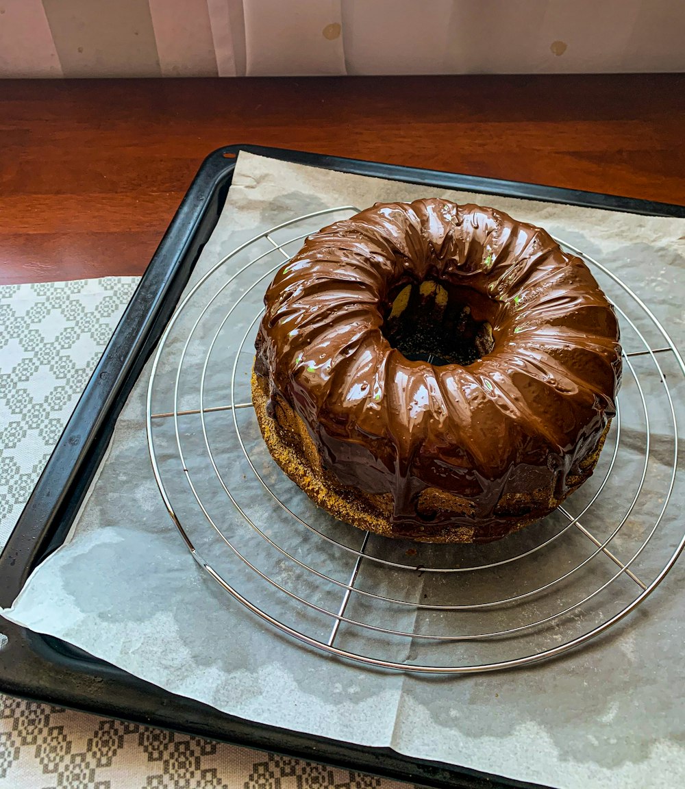 chocolate cake on clear glass round tray