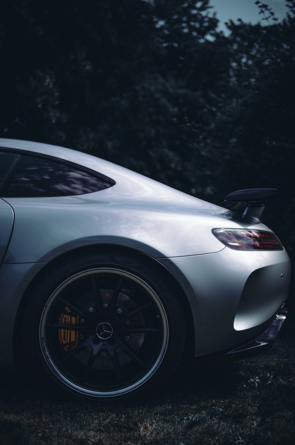 white porsche 911 parked on gray pavement