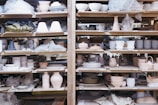 white ceramic teacup on brown wooden shelf
