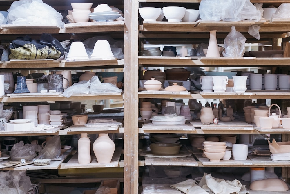 white ceramic teacup on brown wooden shelf