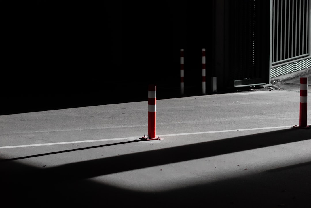 red and white metal post on gray concrete floor