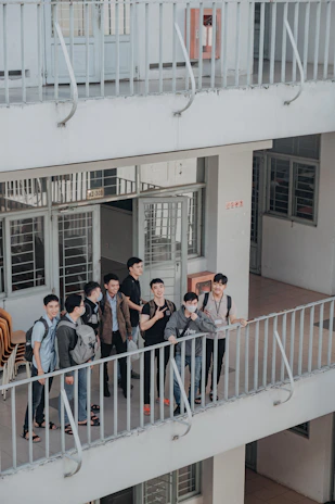 Group of students enjoying a casual chat in the hostel lounge area.
