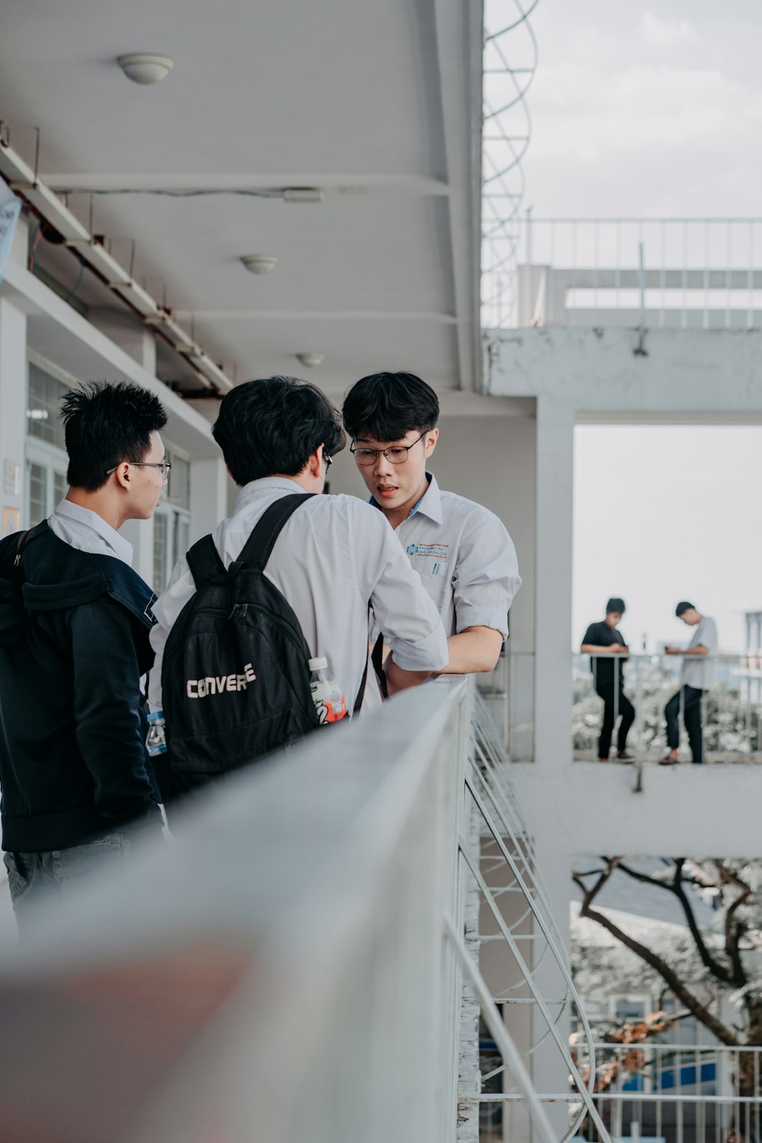 man in white dress shirt standing beside man in black jacket