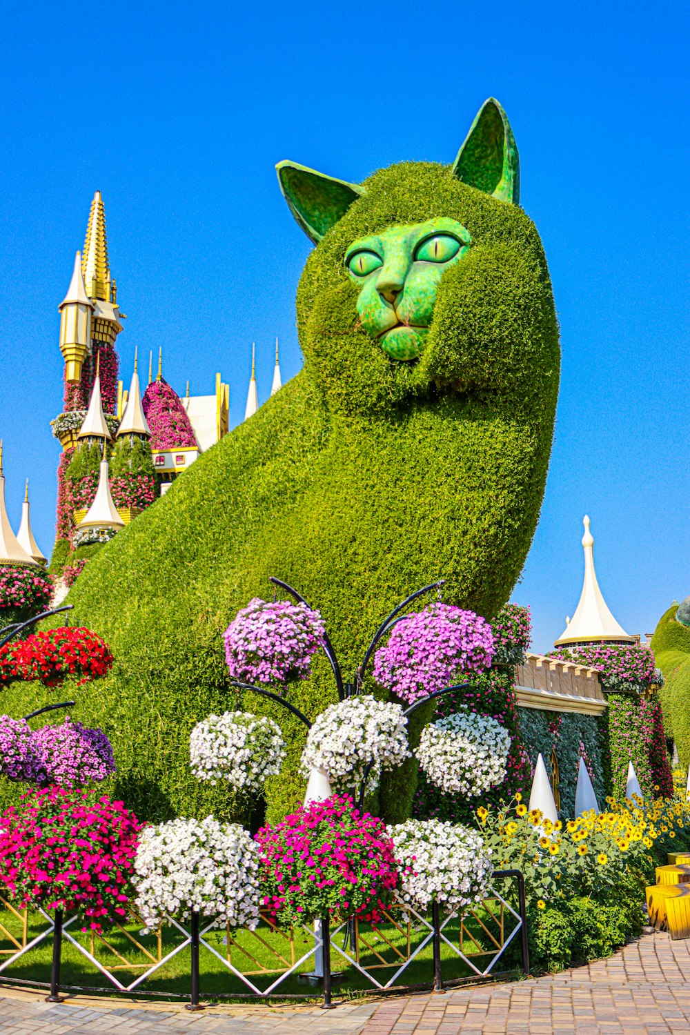 green dragon statue surrounded by purple flowers