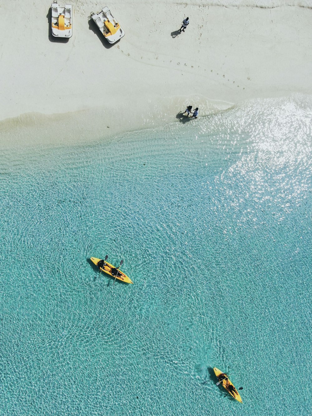 people riding on yellow kayak on sea during daytime