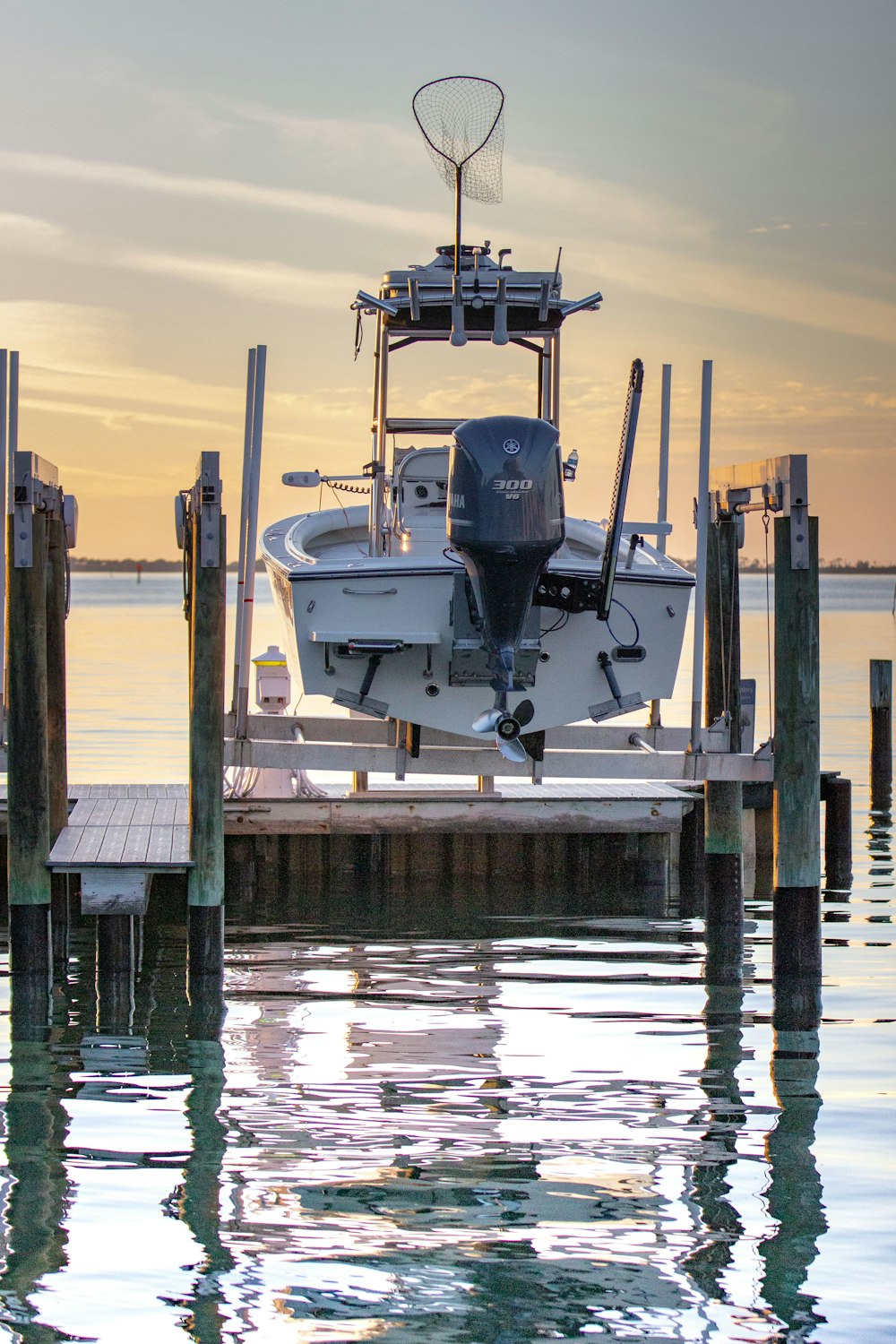 white and black fishing boat on dock during daytime