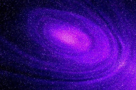 A swirling, cosmic scene with vibrant shades of purple and pink, depicting a galaxy filled with sparkling stars, creating a sense of depth and mystery.