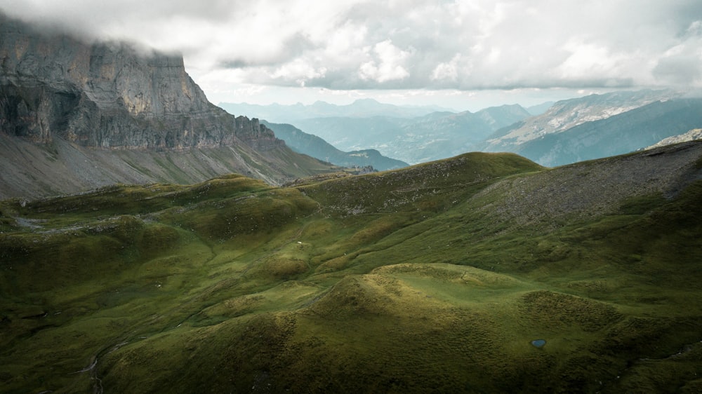 green and brown mountains under white clouds during daytime