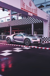 black porsche 911 parked in front of white and brown building