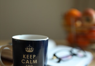 blue and white ceramic mug on brown wooden table