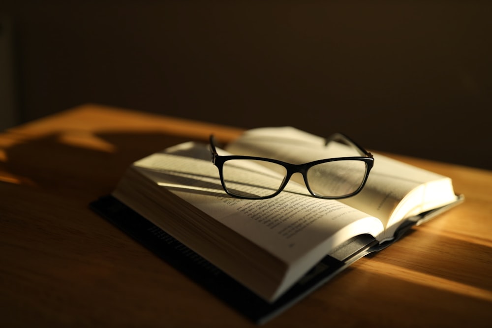 black framed eyeglasses on book page