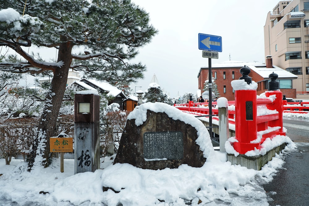 red and white trash bins on snow covered ground