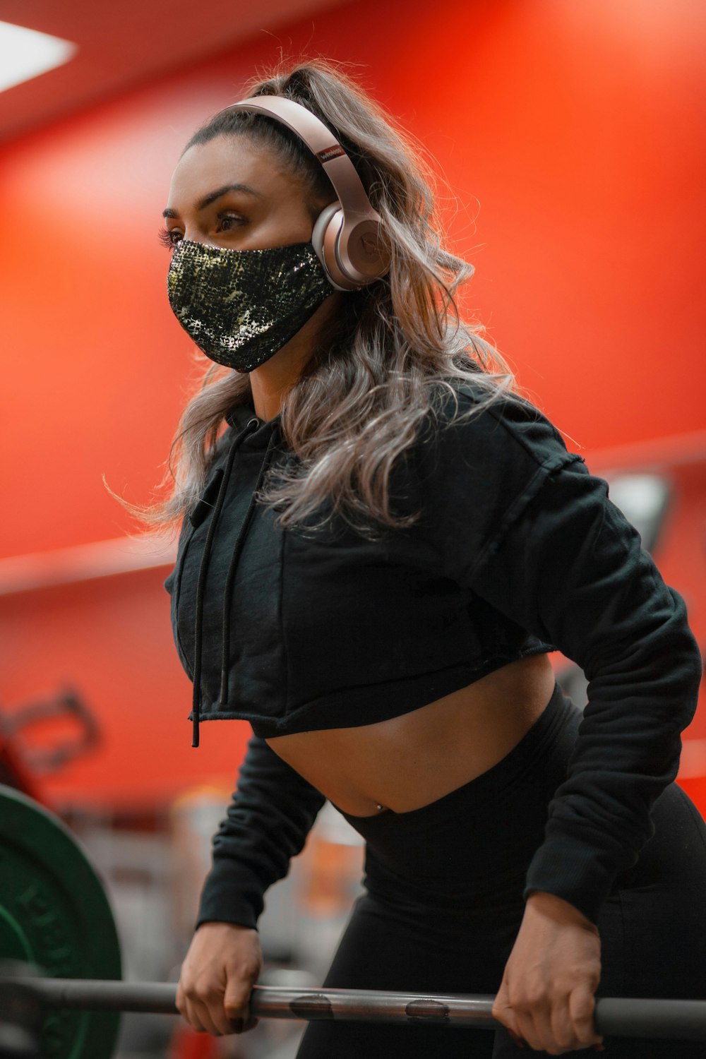 woman in black leather jacket wearing black mask