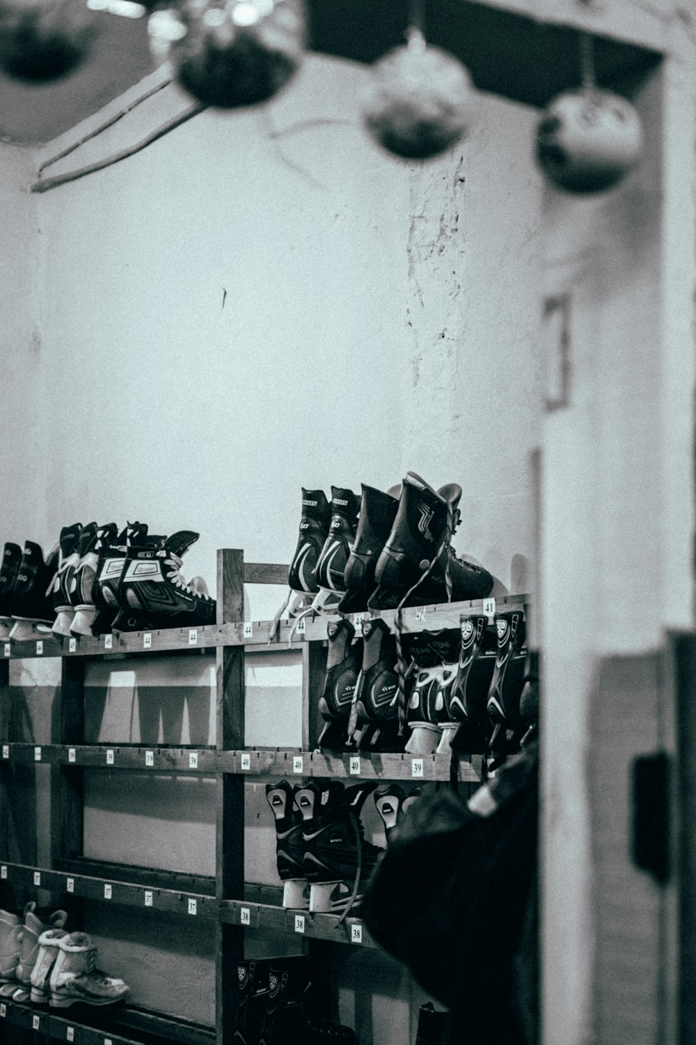 shoes on rack in grayscale photography