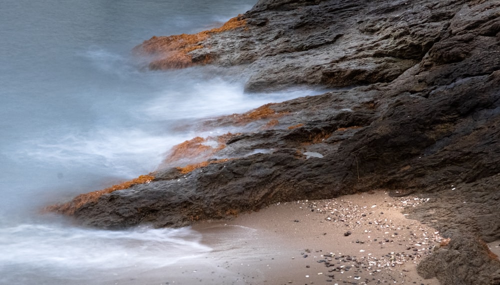 brown rock formation on beach during daytime