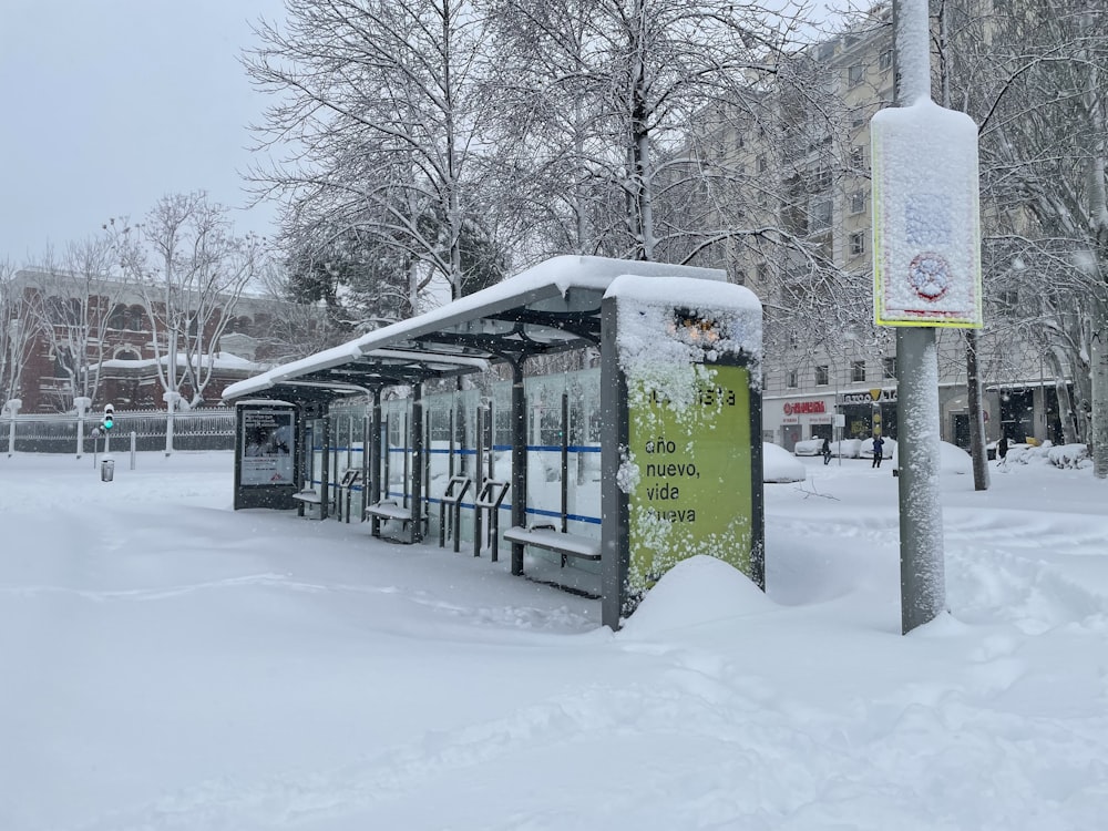 green train on snow covered ground during daytime