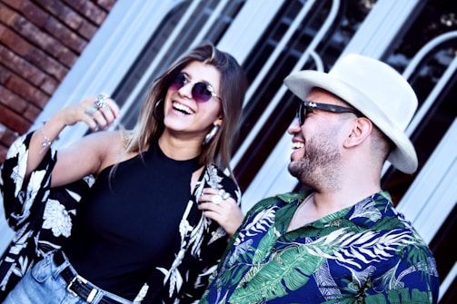 A group of friends laughing while wearing stylish accessories.