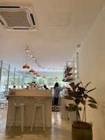 A luxury café interior with minimalist design, featuring copper accents and elegant lighting.