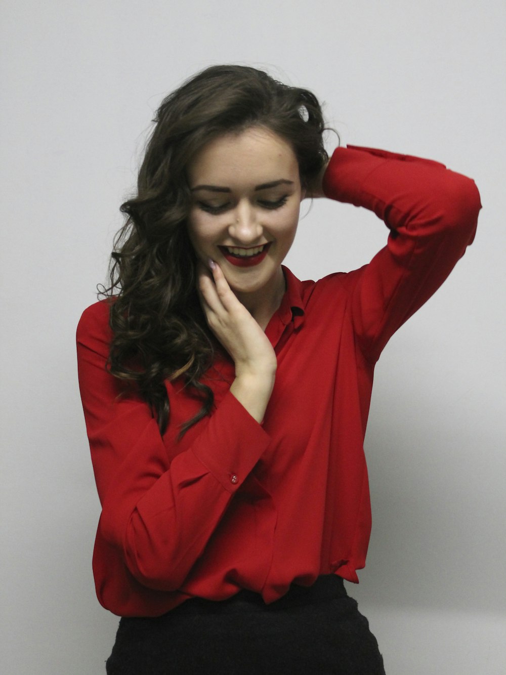 woman in red blazer smiling