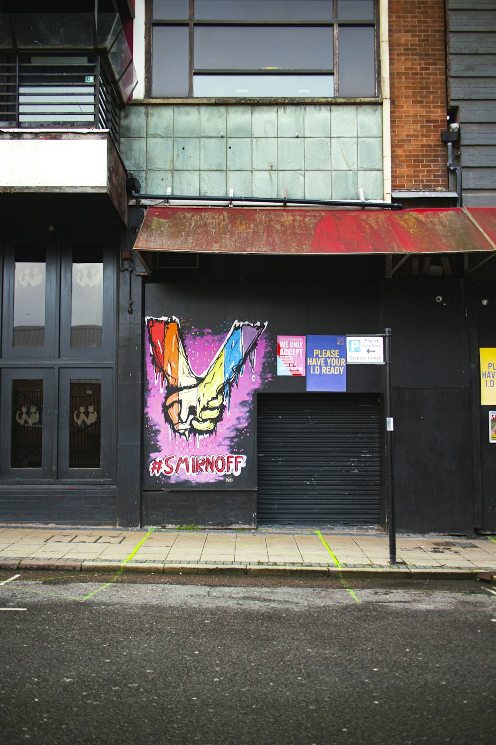 purple and black graffiti on black steel gate