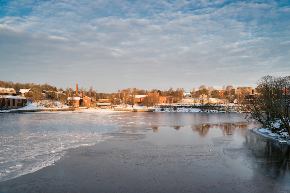 body of water near city buildings under blue sky during daytime