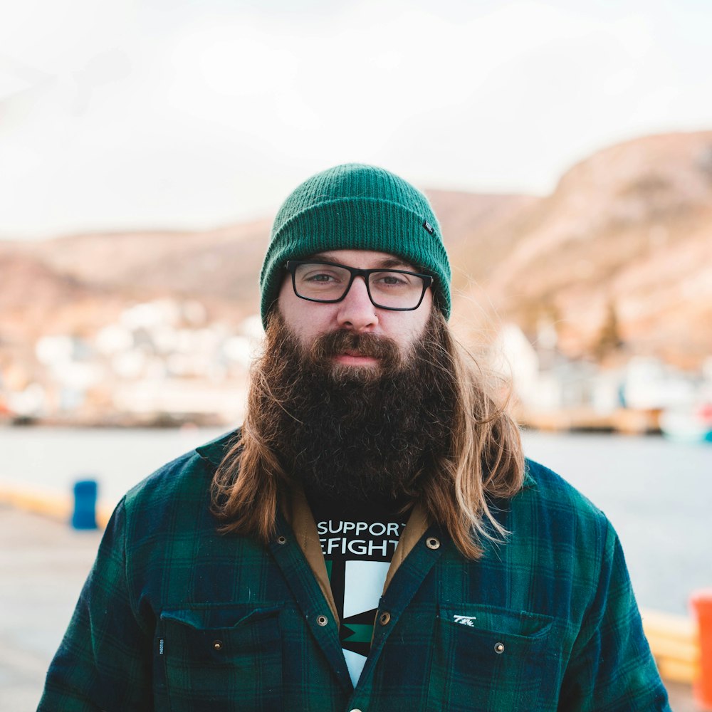 man in green knit cap and blue jacket