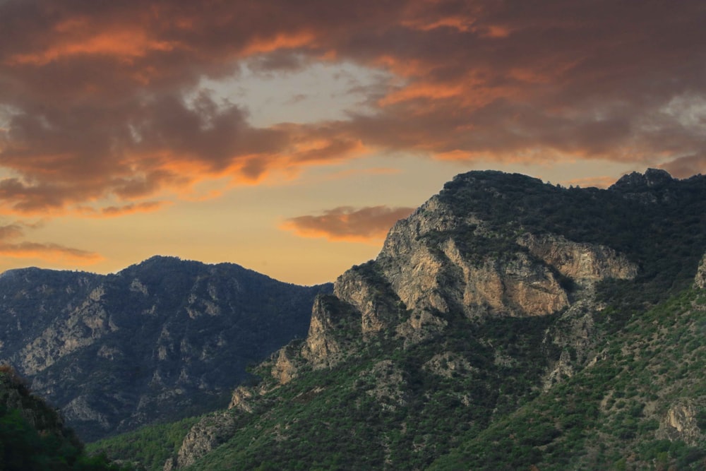 green and brown mountain under cloudy sky during daytime