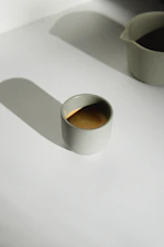 Elegant minimalist cup of coffee surrounded by warm earth tone shadows
