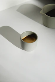 Elegant minimalist cup of coffee surrounded by warm earth tone shadows