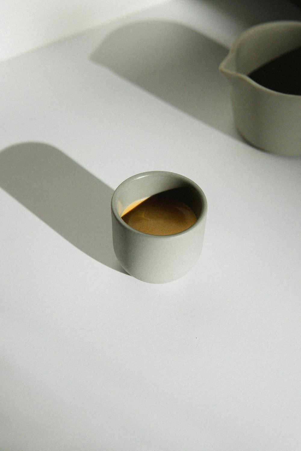 white ceramic mug with brown liquid