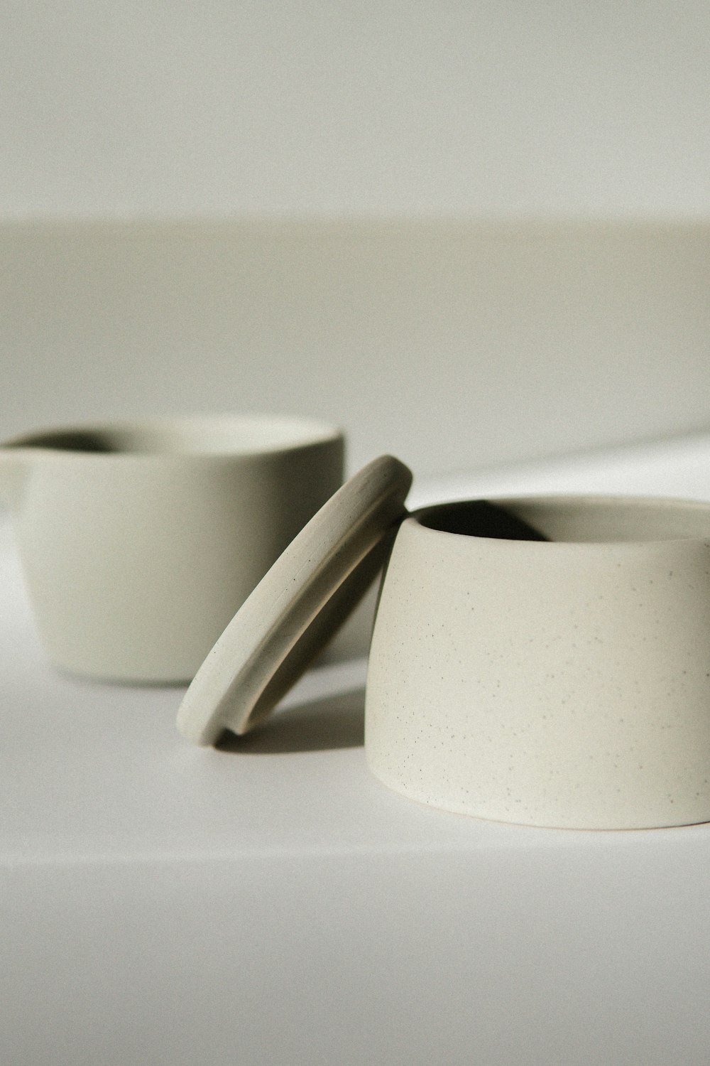 white ceramic mug on white table