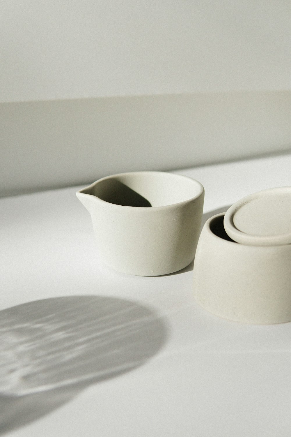 white ceramic pitcher on white table