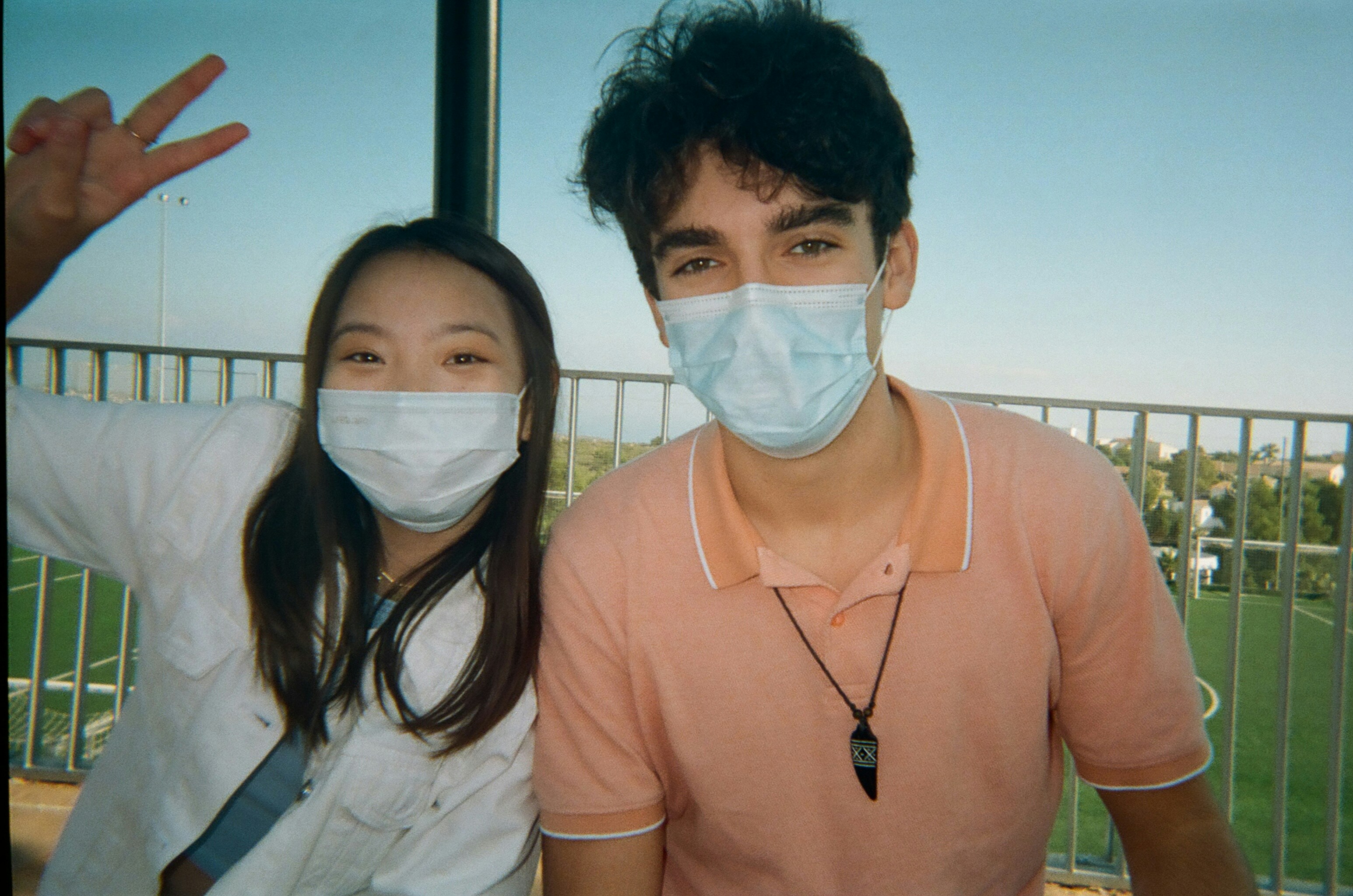 man in brown crew neck shirt beside woman in white shirt