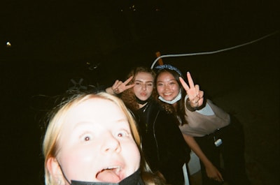 Friends making funny faces and enjoying their photo session at the booth.